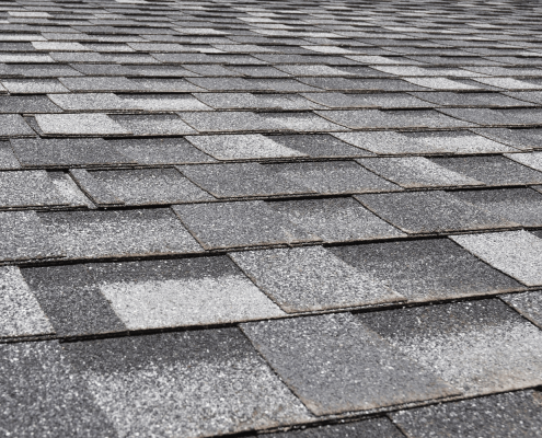 An array of Owens Corning roofing shingles displayed in various colors and styles.